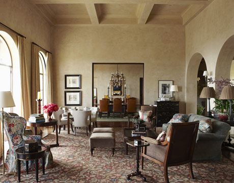 Living Room Lined with Comfort:  Nye started with the Elizabeth Eakins rug in the "elegant but incredibly comfortable" living room, pulling out the colors for the upholstery and pillows. The wing chair is covered in a hand-blocked linen from Hazelton House; the Rose Tarlow Celestial sofa is covered in Morgan velvet by Michael S. Smith. Walls are ivory Venetian plaster. 